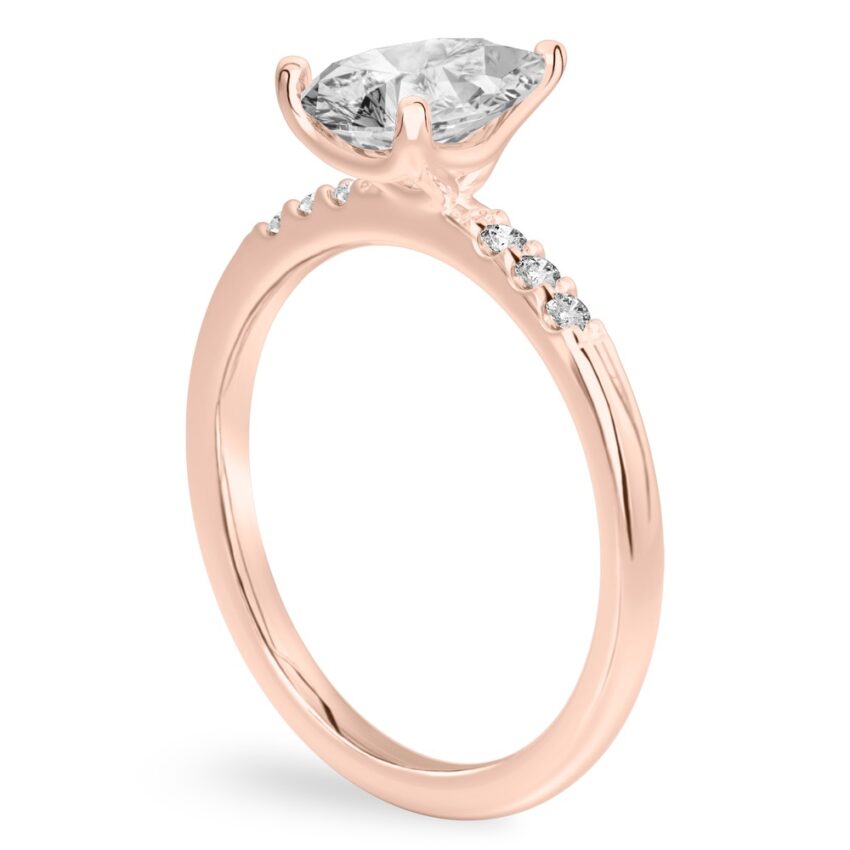 Angle view of pear shape diamond minimalist pave engagement ring in rose gold