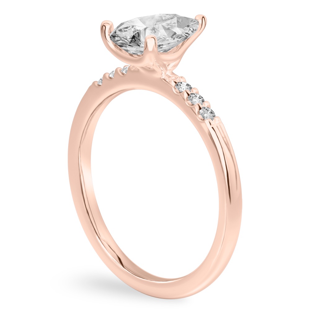 Angle view of pear shape diamond minimalist pave engagement ring in rose gold