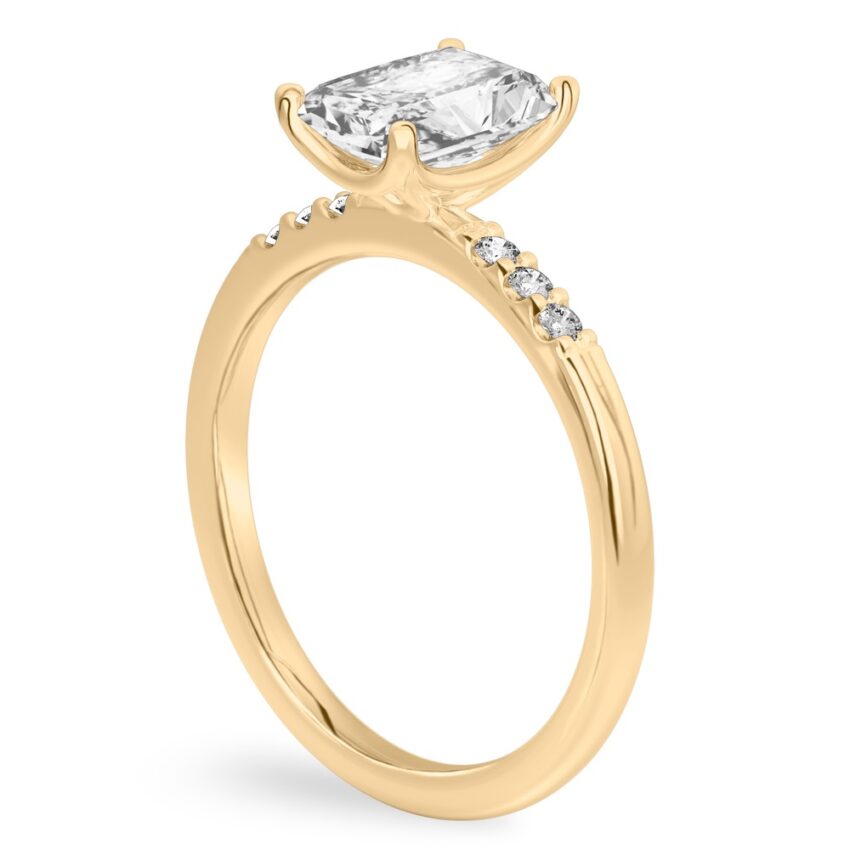Angle view of radiant cut diamond minimalist pave engagement ring in yellow gold