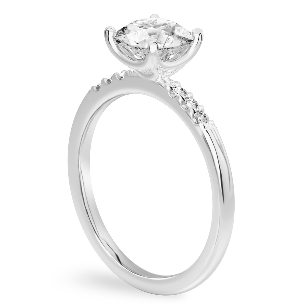 Angle view of round cut diamond minimalist pave engagement ring in platinum