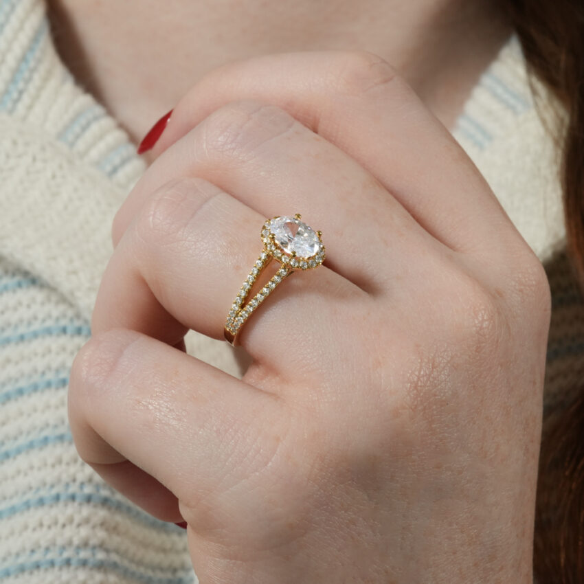 Angle view of split shank halo engagement ring in lifestyle