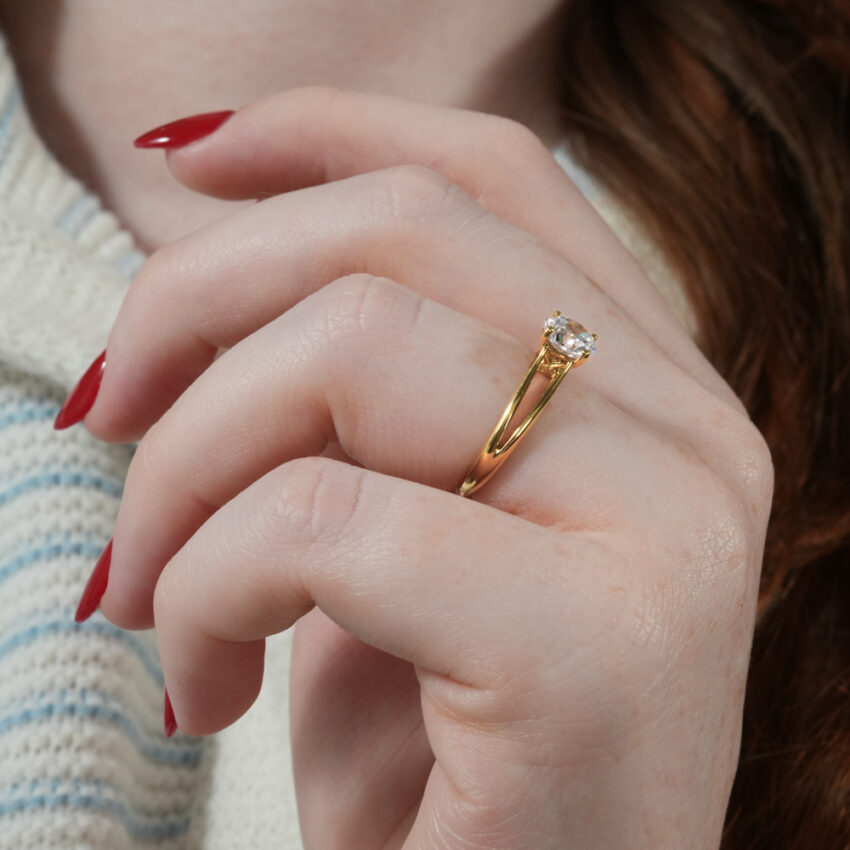 Angle view of unity ring split shank solitaire engagement ring in lifestyle