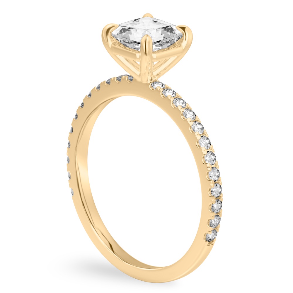 Angle view of asscher cut diamond delicate pave engagement ring in yellow gold