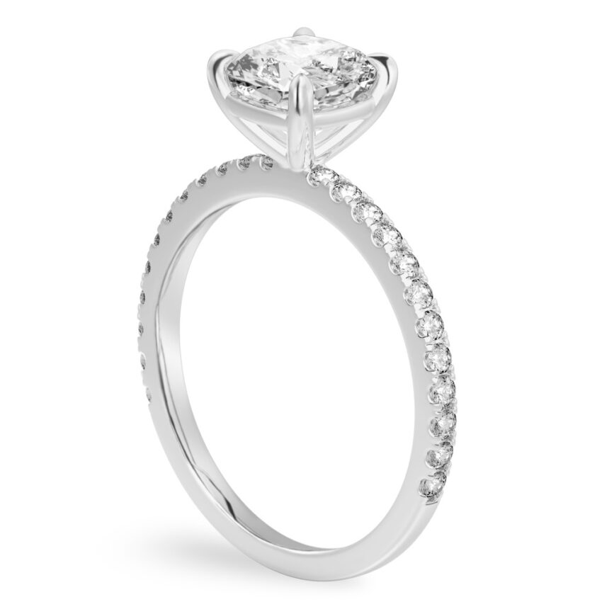 Angle view of cushion cut diamond delicate pave engagement ring in palladium