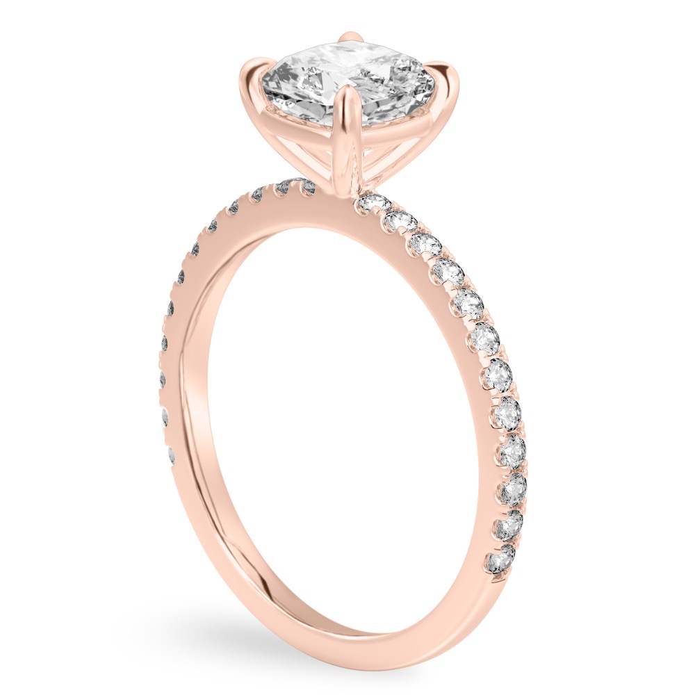 Angle view of cushion cut diamond delicate pave engagement ring in rose gold
