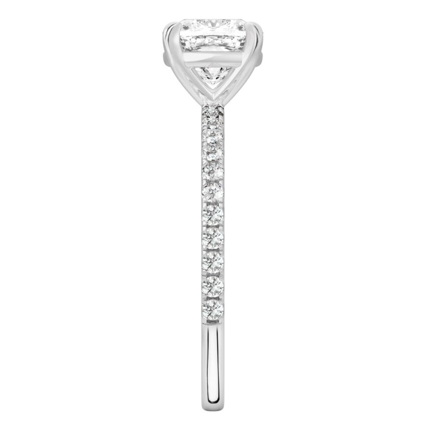 Side view of cushion cut diamond delicate pave engagement ring in white gold