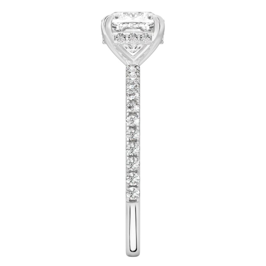 Side view of cushion cut diamond delicate pave hidden halo engagement ring in palladium