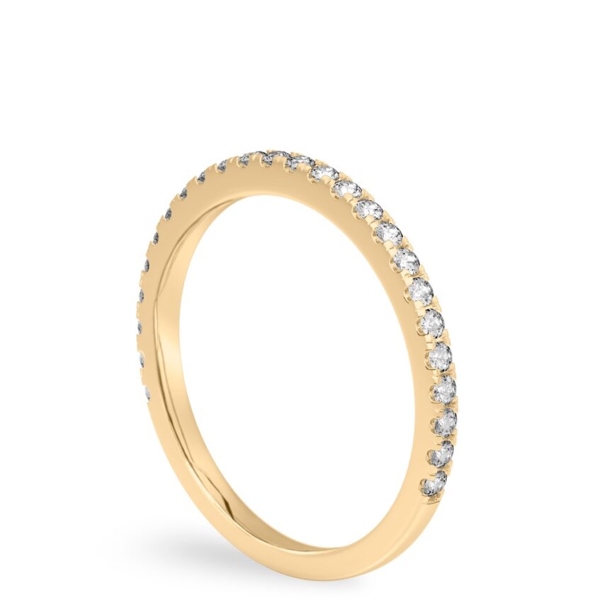 Angle view of delicate pave diamond wedding band in yellow gold