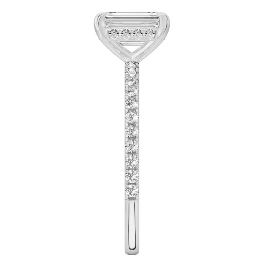 Side view of emerald cut diamond delicate pave hidden halo engagement ring in white gold