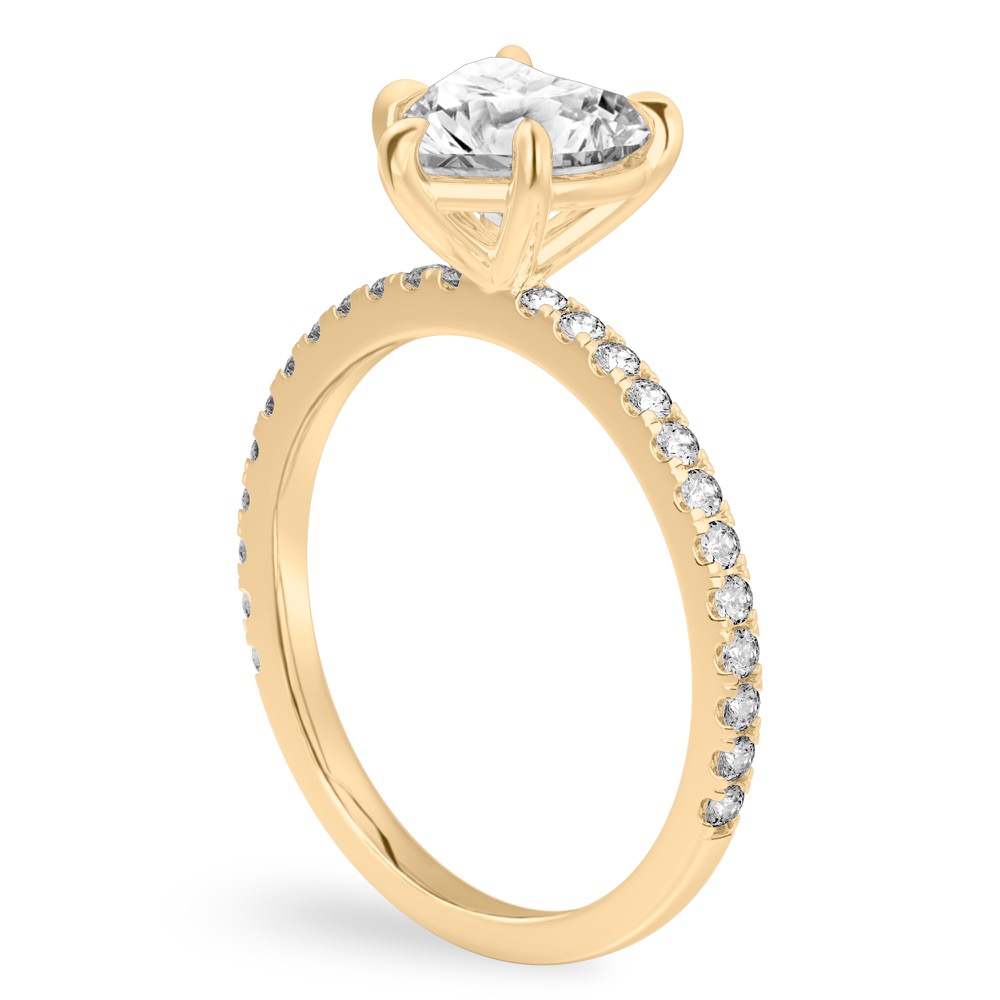 Angle view of heart shape diamond delicate pave engagement ring in yellow gold