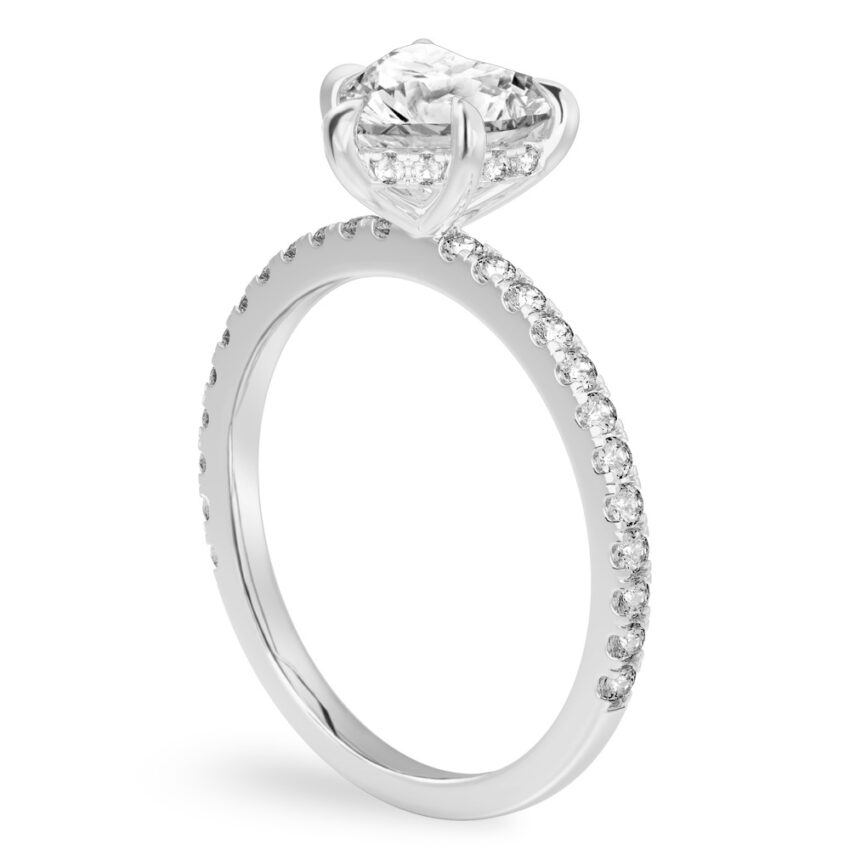 Angle view of heart shape diamond delicate pave hidden halo engagement ring in platinum