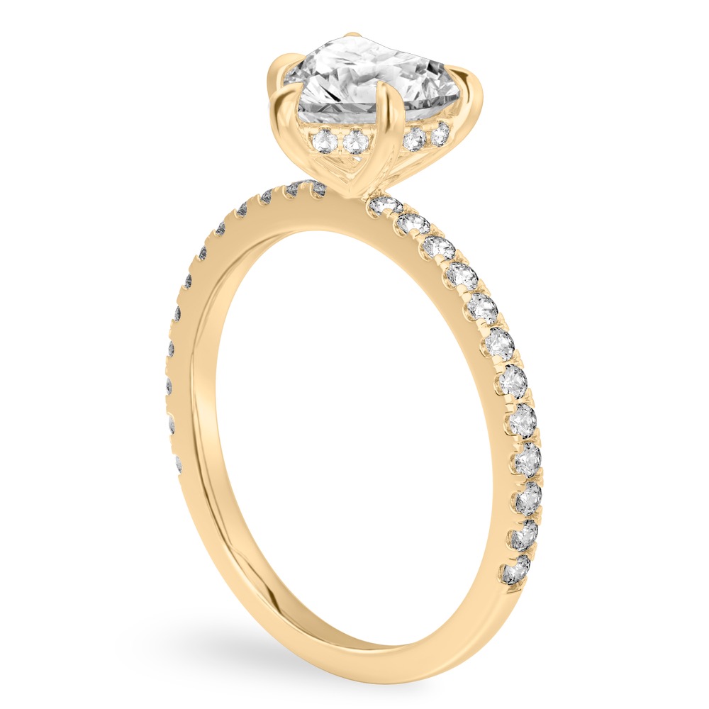 Angle view of heart shape diamond delicate pave hidden halo engagement ring in yellow gold