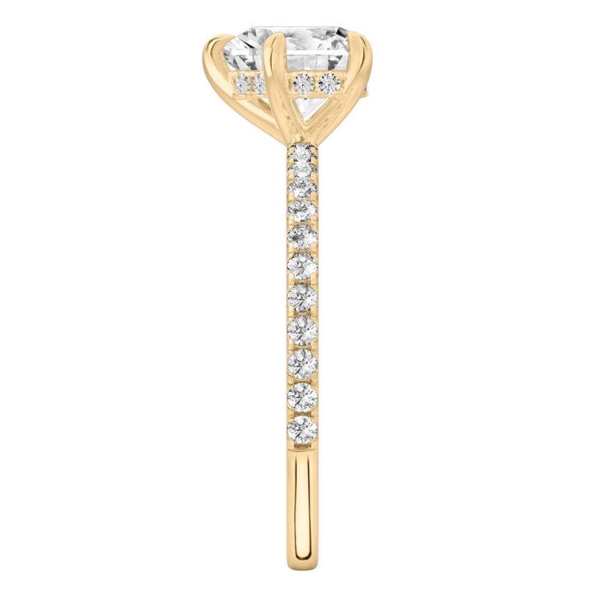 Side view of heart shape diamond delicate pave hidden halo engagement ring in yellow gold