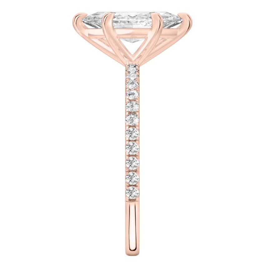Side view of marquise cut diamond delicate pave engagement ring in rose gold