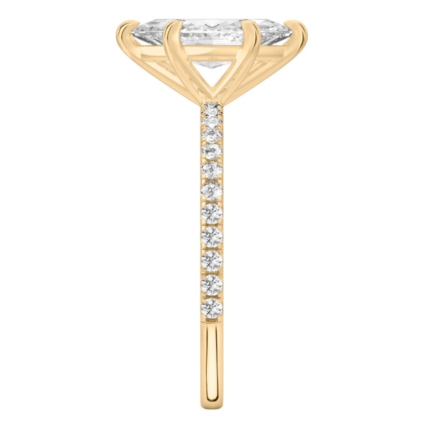 Side view of marquise cut diamond delicate pave engagement ring in yellow gold