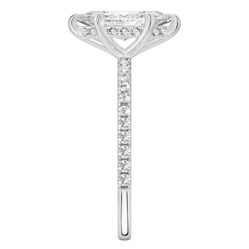 Side view of marquise cut diamond delicate pave hidden halo engagement ring in platinum