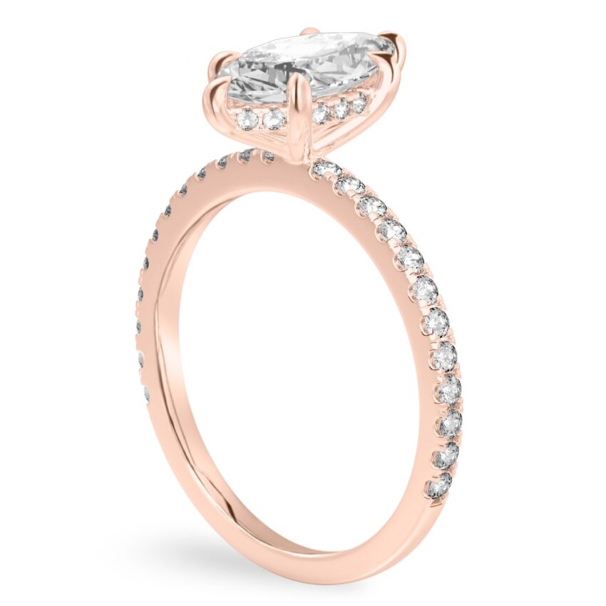 Angle view of marquise cut diamond delicate pave hidden halo engagement ring in rose gold