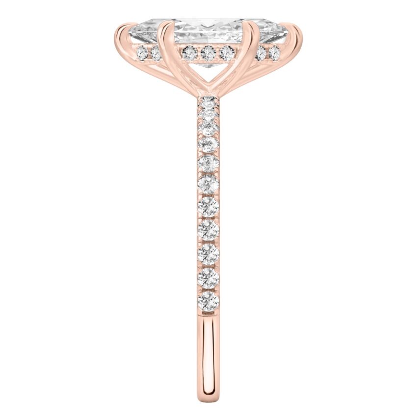 Side view of marquise cut diamond delicate pave hidden halo engagement ring in rose gold