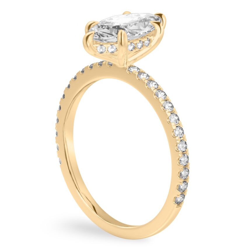 Angle view of marquise cut diamond delicate pave hidden halo engagement ring in yellow gold