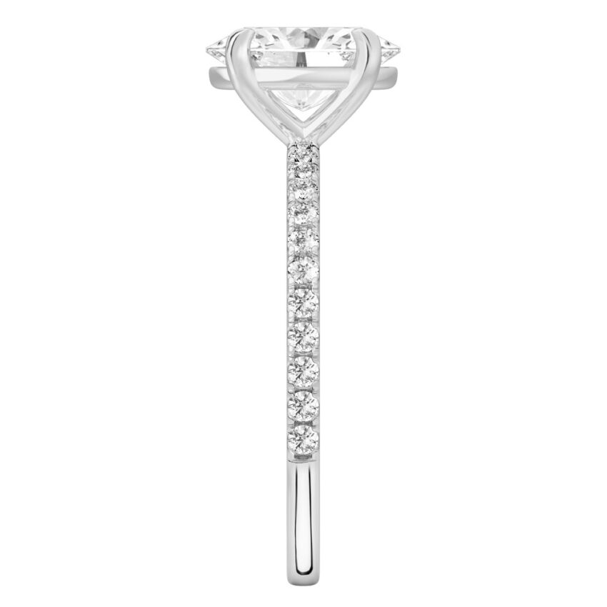 Side view of oval cut diamond delicate pave engagement ring in platinum