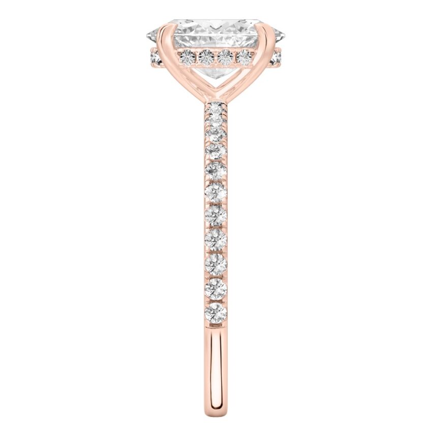 Side view of oval cut diamond delicate pave hidden halo engagement ring in rose gold