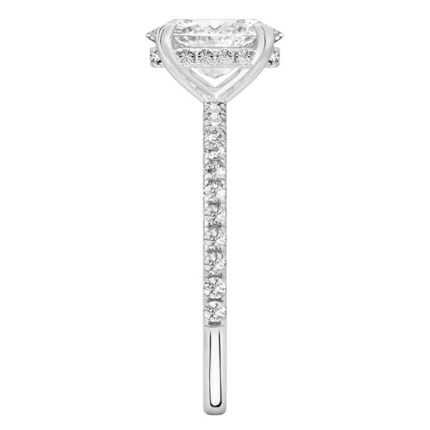 Side view of oval cut diamond delicate pave hidden halo engagement ring in white gold