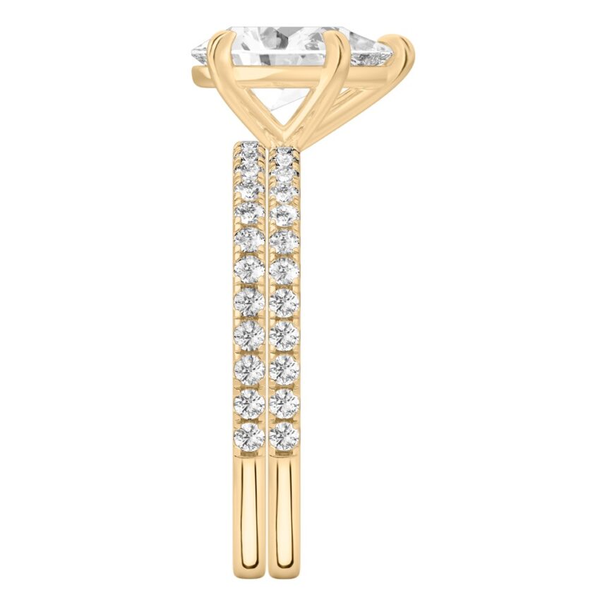 Side view of pear shape diamond delicate pave engagement ring set yellow gold