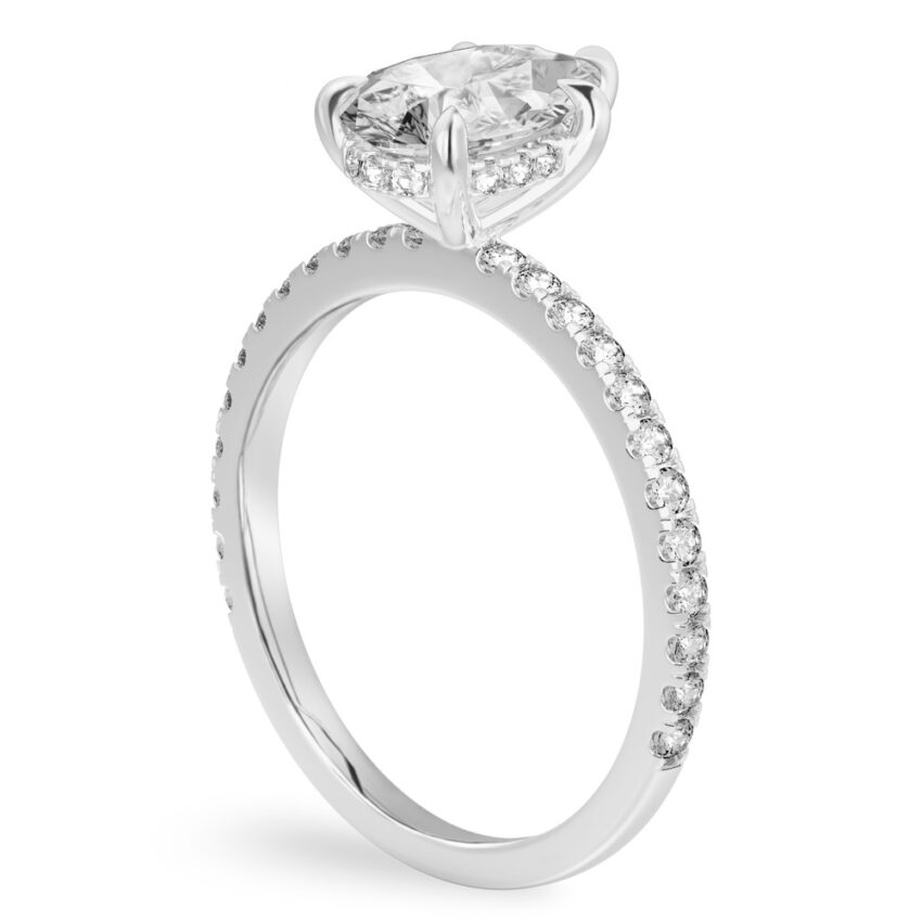 Angle view of pear shape diamond delicate pave hidden halo engagement ring in platinum