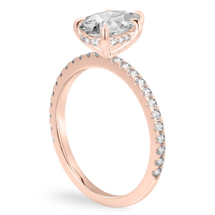 Angle view of pear shape diamond delicate pave hidden halo engagement ring in rose gold