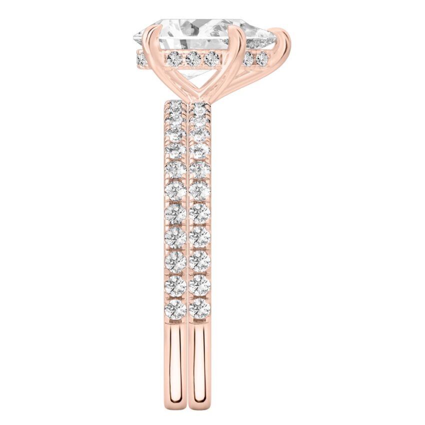 Side view of pear shape diamond delicate pave hidden halo engagement ring set rose gold