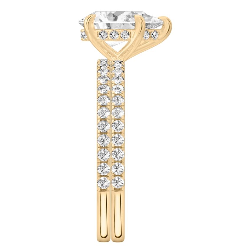 Side view of pear shape diamond delicate pave hidden halo engagement ring set yellow gold