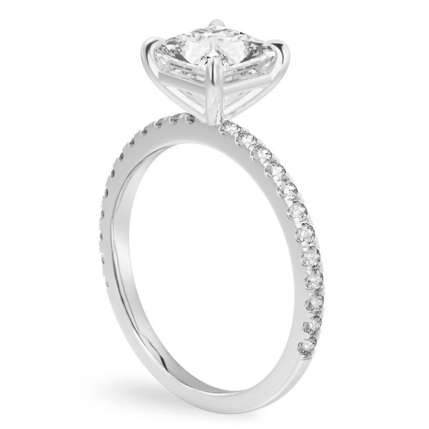 Angle view of princess cut diamond delicate pave engagement ring in platinum