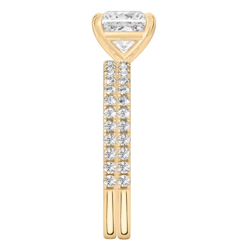 Side view of princess cut diamond delicate pave engagement ring set yellow gold