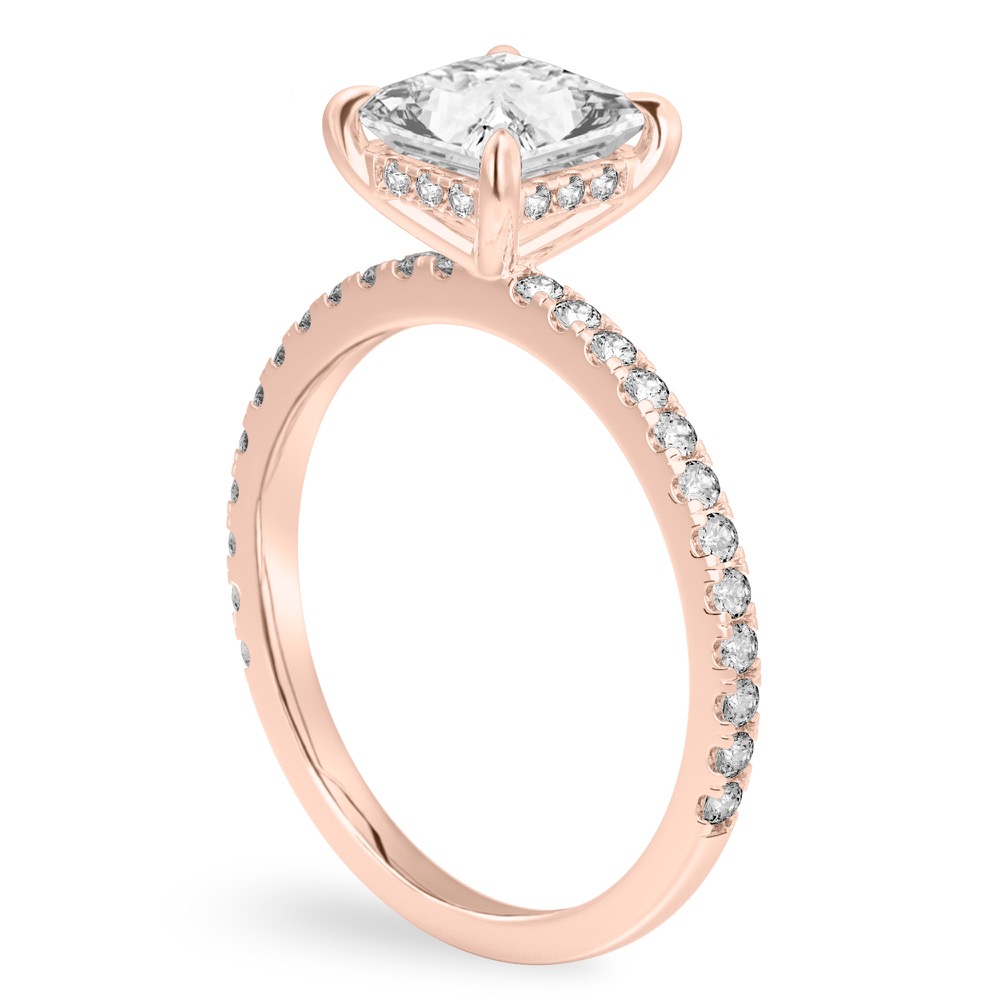 Angle view of princess cut diamond delicate pave hidden halo engagement ring in rose gold