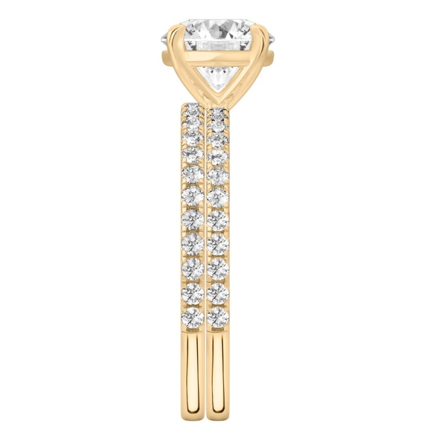 Side view of round cut diamond delicate pave engagement ring set yellow gold