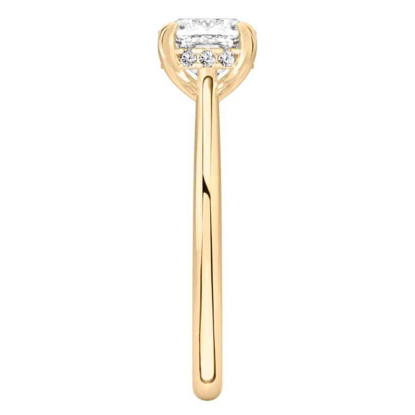 Side view of cushion cut diamond pave bridge engagement ring in yellow gold