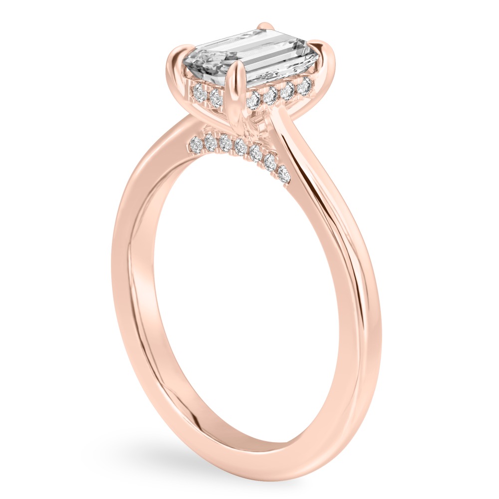 Angle view of emerald cut diamond pave bridge engagement ring in rose gold
