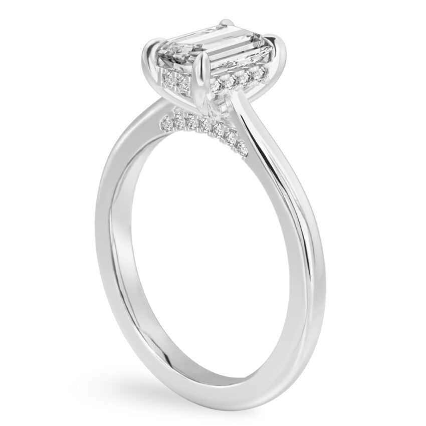 Angle view of emerald cut diamond pave bridge engagement ring in white gold