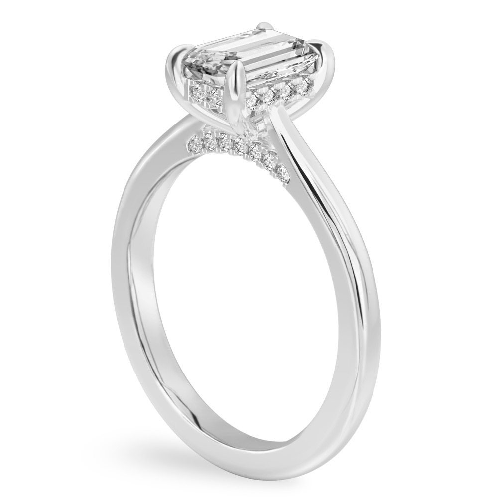 Angle view of emerald cut diamond pave bridge engagement ring in white gold