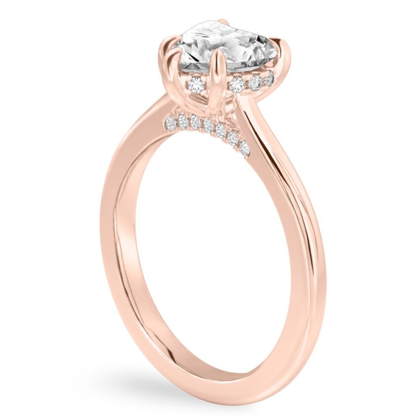 Angle view of heart shape diamond pave bridge engagement ring in rose gold