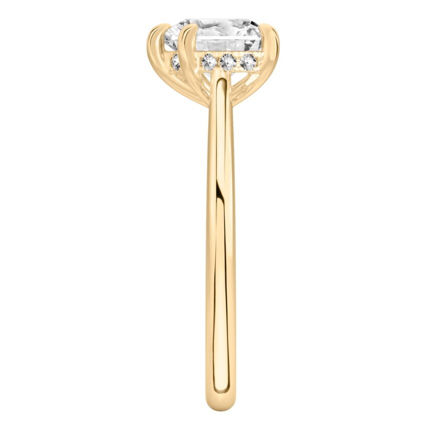 Side view of heart shape diamond pave bridge engagement ring in yellow gold