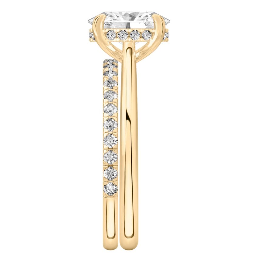 Side view of oval cut diamond pave bridge engagement ring set yellow gold