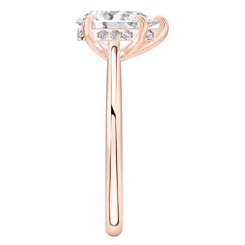 Side view of pear shape diamond pave bridge engagement ring in rose gold