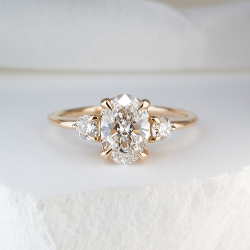 1.19 Carat Oval Cut Diamond Three Stone Engagement Ring Yellow Gold Lifestyle