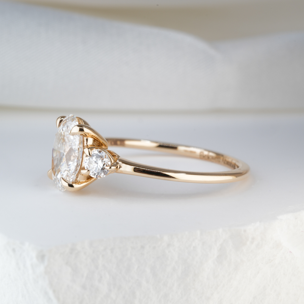 1.19 Carat Oval Cut Diamond Three Stone Engagement Ring Yellow Gold Lifestyle Side