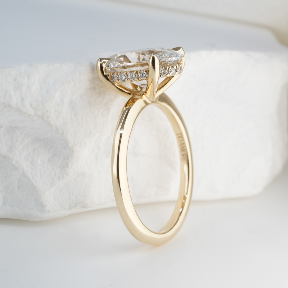 2.0 Carat Oval Cut Diamond Ultra Low Hidden Halo Engagement Ring Yellow Gold Lifestyle Angle