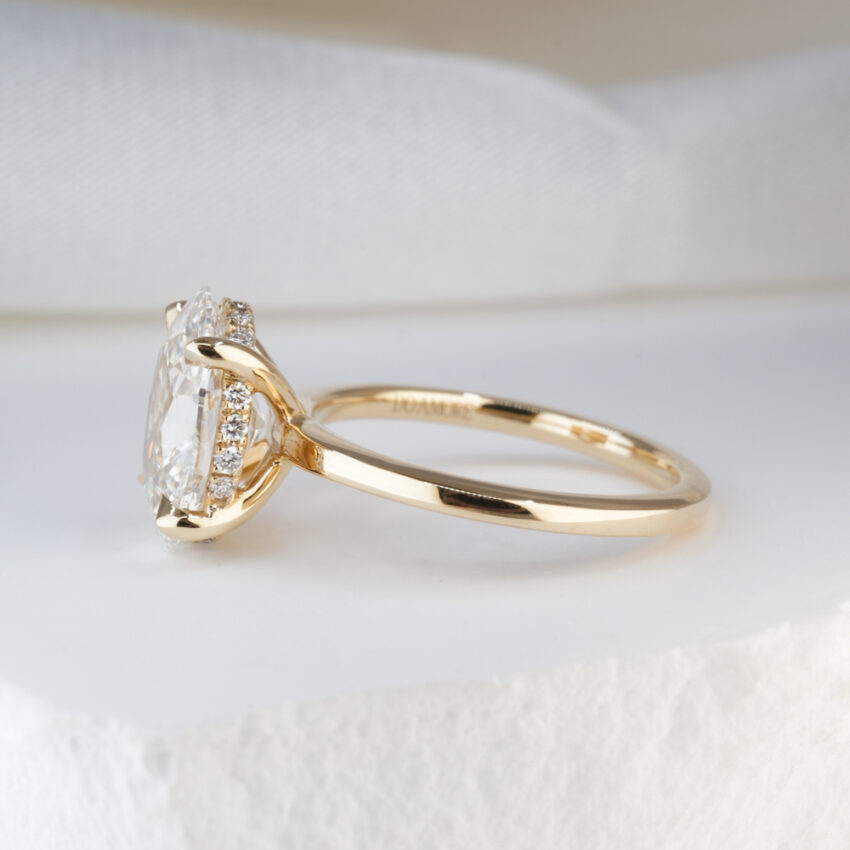 2.0 Carat Oval Cut Diamond Ultra Low Hidden Halo Engagement Ring Yellow Gold Lifestyle Side