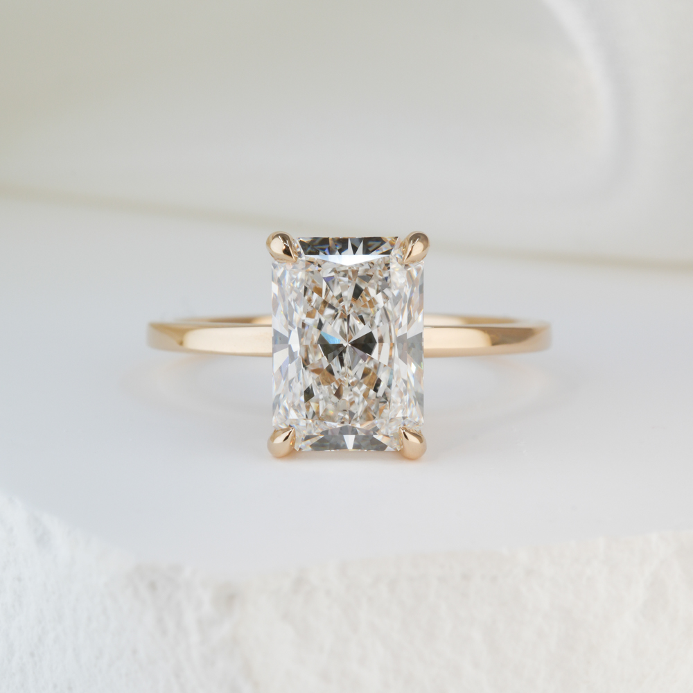 2.43 carat radiant cut diamond ultra low hidden halo engagement ring in yellow gold lifestyle