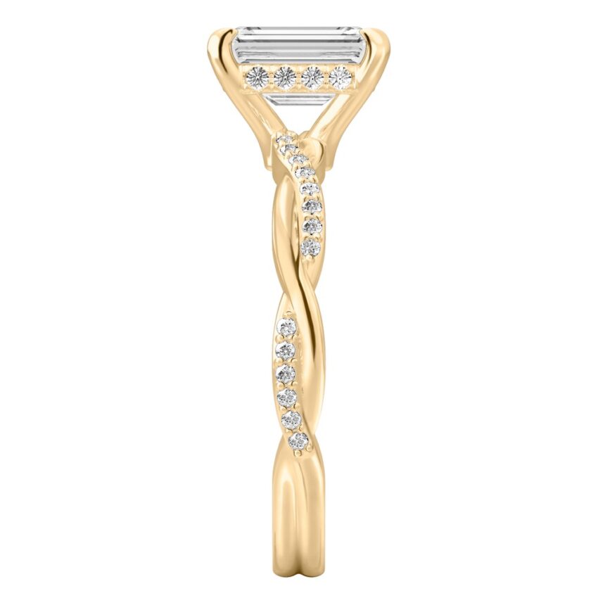 Side view of emerald cut diamond twist hidden halo engagement ring in yellow gold
