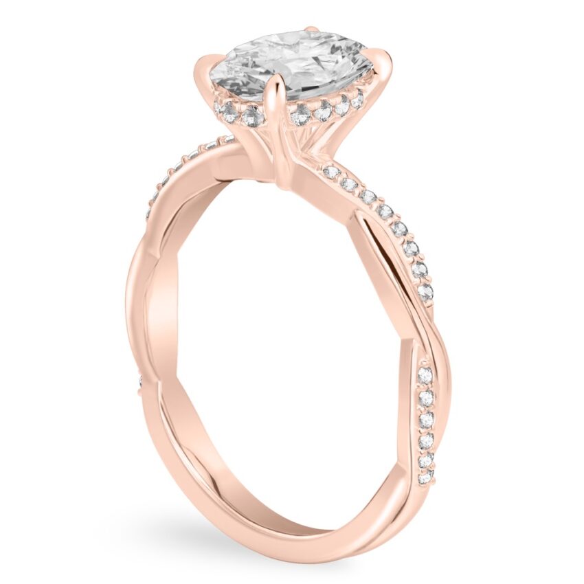 Angle view of oval cut diamond twist hidden halo engagement ring in rose gold